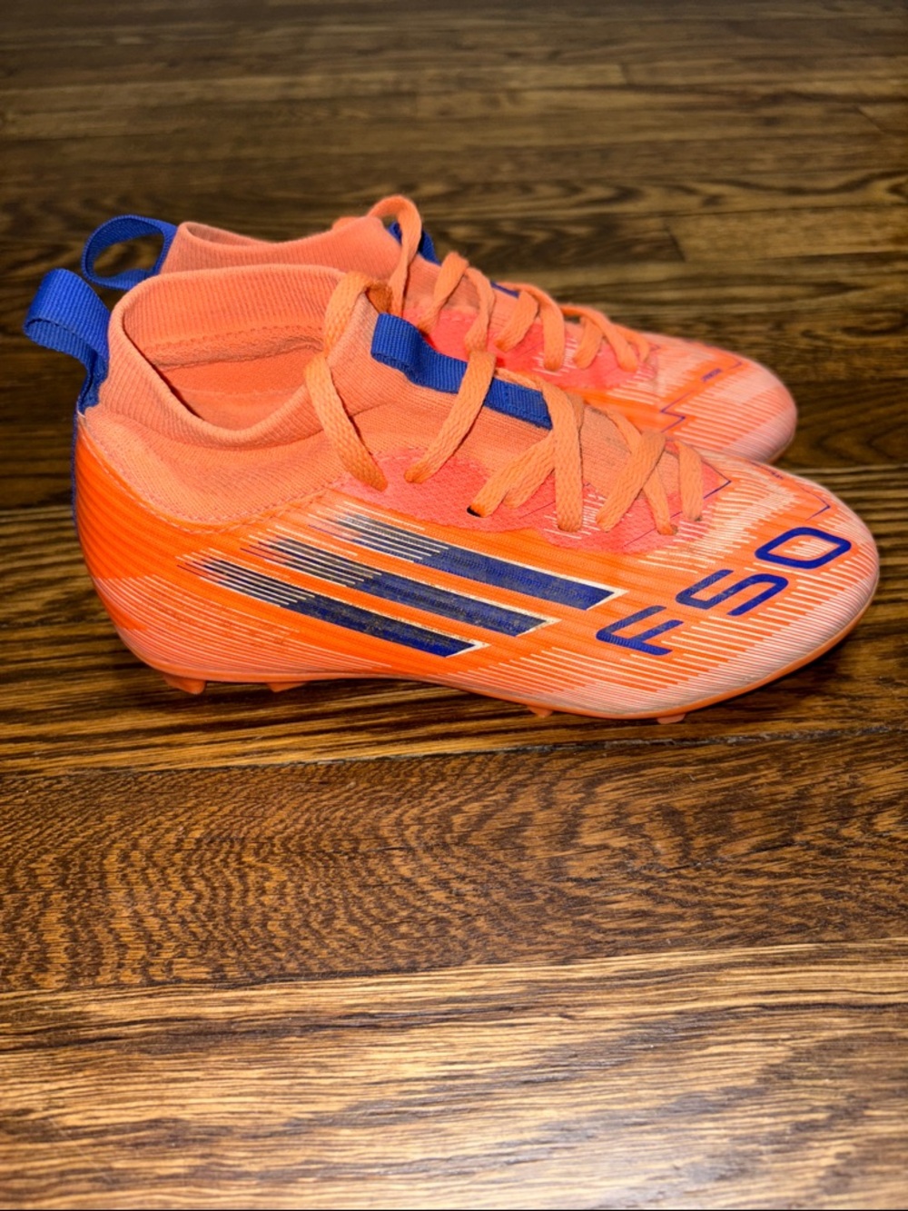 The adidas soccer cleats Kids F50 League FG/MG Orange/Lucid Blue Size 1